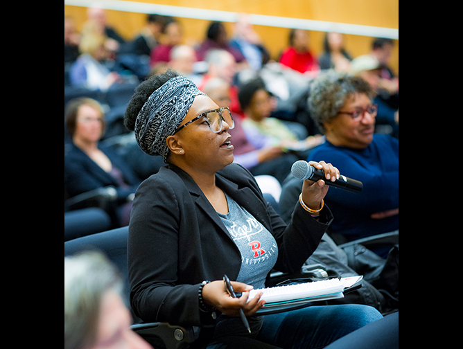 a woman in the audience listening to Jeh Johnson’s morning keynote